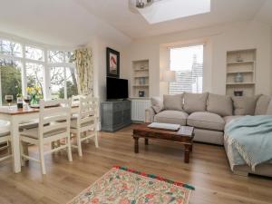 a living room with a couch and a table at Summerhow Retreat in Kendal