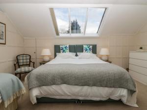 a bedroom with a large bed and a window at Summerhow Retreat in Kendal