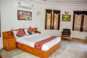 a bedroom with a bed and a chair at RESORT FARM VILLA in Bhuj
