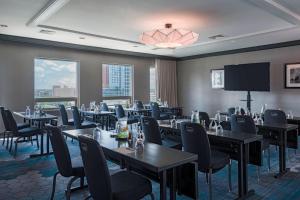 a restaurant with tables and chairs and a projection screen at Renaissance Baltimore Harborplace Hotel in Baltimore