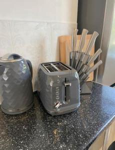 two toasters sitting on top of a kitchen counter at Ideal for Contractors' Accommodation in Seacombe