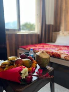 a table with fruit on it in a hotel room at Stay With Prarambha in Rishīkesh