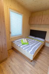 a bedroom with a bed in a wooden room at Mobile Homes Camping Reiter in Greifenburg