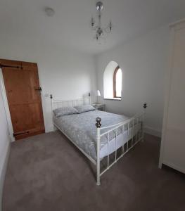 a bedroom with a bed and a window and a door at Kinley Tower 