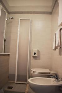 a bathroom with a shower and a toilet and a sink at Hotel Edelweiss in Lido di Jesolo