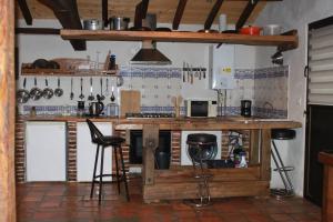 a kitchen with a counter and stools in a room at Villa de 2 chambres avec piscine partagee terrasse et wifi a Pontonx sur l'Adour in Pontonx-sur-lʼAdour