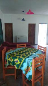 a bedroom with a bed with a colorful quilt on it at Bosquecito de Carpin in Carpintería