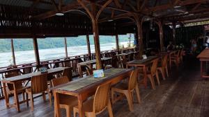 a row of tables and chairs in a restaurant at The Jeti Mangrove - Ecolodge, Cottage, Restaurant & Kali Biru, Blue River in Rabia +60 photos