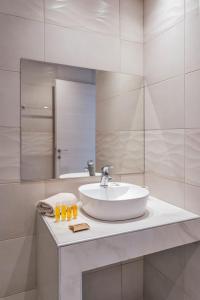 a bathroom with a sink and a mirror at Beach Break Rhodes in Faliraki