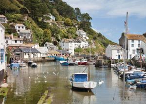 a boat is docked in a marina with houses at Stunning Home In Looe W- in Looe