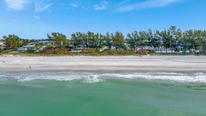 a view of a beach with the ocean at Island Hideaway steps to beach dock Bridge St in Bradenton Beach