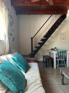 a room with a bed and a staircase with a table at Los Martínez Apart in Paganini