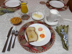 a breakfast plate with eggs and toast on a table at HOTEL SANTA ANA LUXURY RENTALS in Bogotá