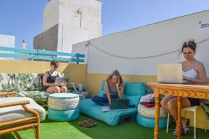 a group of women sitting on chairs with their laptops at Daydream Medano Coliving in El Médano