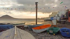 a group of boats sitting on the beach at Daydream Medano Coliving in El Médano