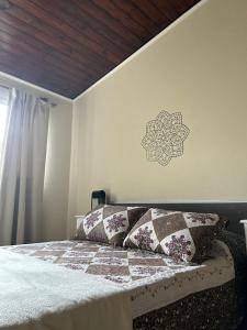 a bedroom with a bed with a mandala on the wall at Los Martínez Apart in Paganini