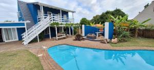 a house with a swimming pool in front of a house at Island Flip Flop Holidays in Sedgefield