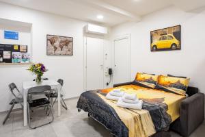 a bedroom with a bed with a table and a yellow car on the wall at Petite House Frascati in Frascati