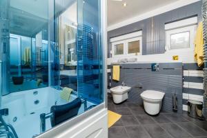 a bathroom with a tub and a toilet and a sink at Apartmani Višnja in Crikvenica +33 photos