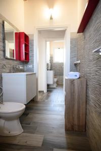 a bathroom with a toilet and a sink and a mirror at Risa Apulia in Torre Lapillo +60 photos
