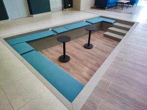 a swimming pool with two stools in a building at The Hood 102, Modern and Luxury Apartments in Bogotá