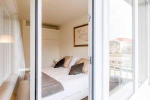 a small room with a bed and a window at Luxury Leie View in Ghent