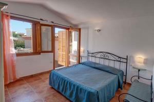 En eller flere senge i et værelse på Apartments in Budoni 39547
