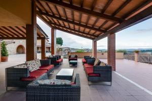 a covered patio with couches and chairs and a table at Apartments in Magliano in Toscana - Maremma-Küste 48277 in Magliano in Toscana