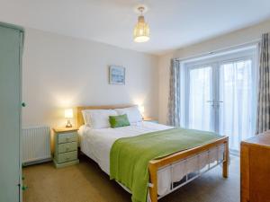 a bedroom with a bed and a large window at 3 Bed in Brixham BX002 in Brixham