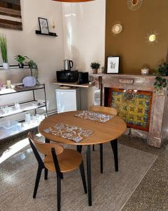 a table and chairs in a room with a fireplace at Monsieur Michel in Dinant