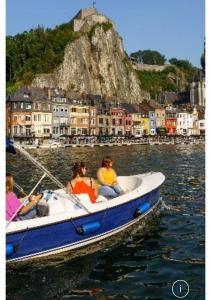 a group of people in a boat in the water at Monsieur Michel in Dinant