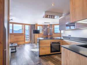 a kitchen with wooden cabinets and a stove top oven at Appartement Avoriaz, 4 pièces, 8 personnes - FR-1-314-129 in Avoriaz