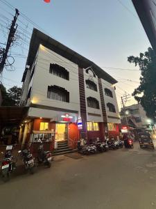 a group of motorcycles parked in front of a building at Hotel Prabha in Ratnagiri