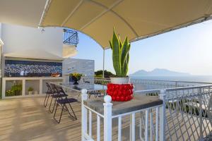 a balcony with a table and a potted plant at AMORE RENTALS - Villa Domus Franca in Massa Lubrense