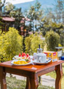 a table with a plate of food on it at Glamping Campo Lago San Pablo in Otavalo