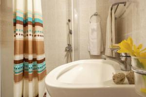a bathroom with a sink and a shower curtain at Villa Antigoni in Alikias +33 photos