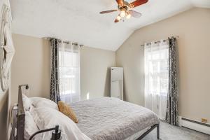 a bedroom with a bed and a ceiling fan at Downtown Westerly Home 4 Mi to Beaches! in Westerly