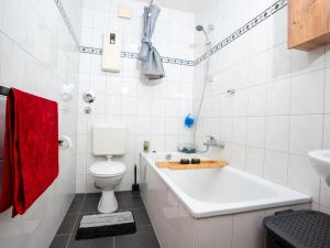a white bathroom with a toilet and a bath tub at SR24 - Space mit Terrasse in Duisburg in Duisburg