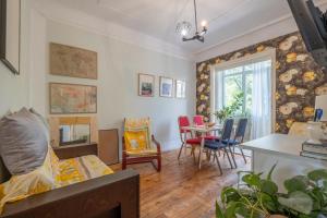 a living room with a bed and a table and chairs at Classy apartment in Sofia