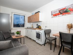 a kitchen and living room with a couch and a table at SR24 - Space mit Terrasse in Duisburg in Duisburg