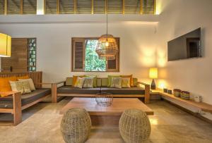 a living room with a couch and a table at Shawandha Villas in Punta Uva