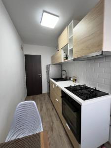 a small kitchen with a stove and a sink at Bianca's Place in Piteşti