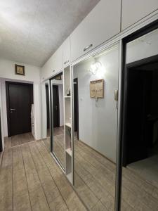 an empty room with glass doors and a wall at Bianca's Place in Piteşti