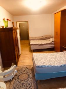 a small room with two beds and a mirror at Pension Stein bei nürnberg in Stein bei Nürnberg