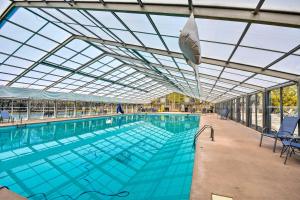 a large swimming pool with a glass ceiling at Cozy Ellijay Cabin Hot Tub, Yard, and Resort Access in Ellijay