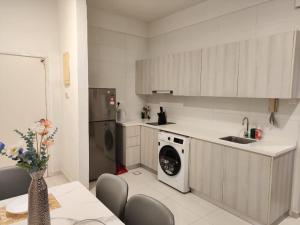 a kitchen with a washing machine and a sink at SKS PAVILLION Cozy Studio With Netflix WiFi Car Park in Johor Bahru