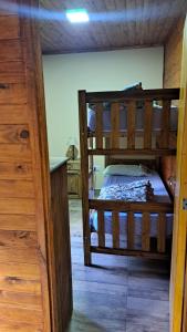 a bedroom with two bunk beds in a room at Cabaña potrerillos La Tabaida in Potrerillos