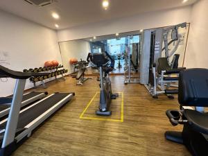 a gym with treadmills and machines in a room at SKS PAVILLION Cozy Studio With Netflix WiFi Car Park in Johor Bahru