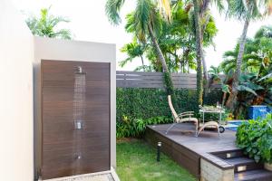 una terrazza in legno con tavolo e sedie. di Garden Oasis 1 Villa With Private Pool a Four Roads