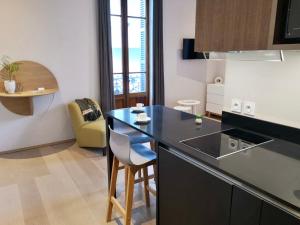 a kitchen with a black counter top in a room at Villa Saint Enogat in Aix-les-Bains